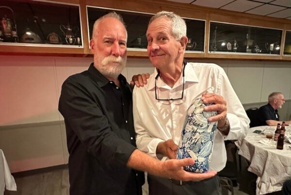 Jim Macnie and Tom Bouchard with Kathy Brown's belated ceramic gift to the high school, 52 years after a mosaic pledged by the class during graduation never turned up.